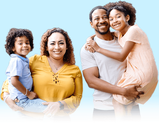 A family portrait featuring a couple with two children, smiling together in a warm, outdoor setting.