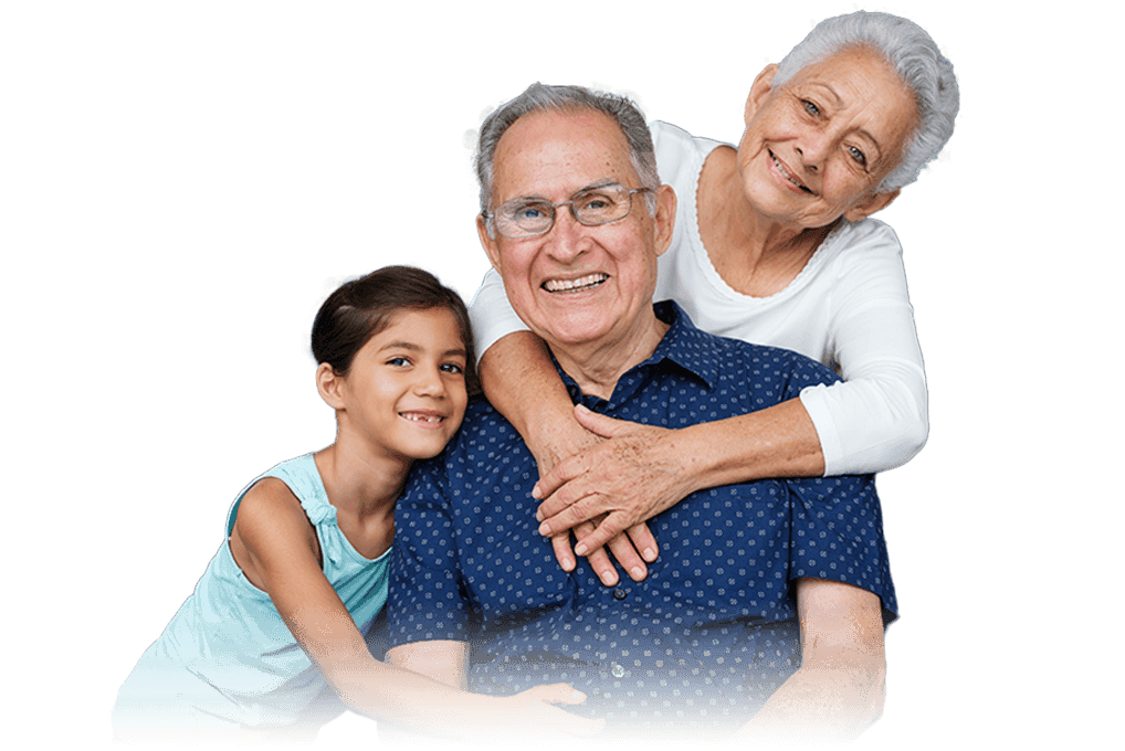 An elderly couple with their two children, all smiling in a family setting.